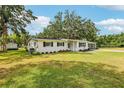 A charming single-story home is set on a large lot with a well maintained lawn and mature landscaping at 403 Westbrook Ave, Brandon, FL 33511