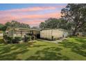 Expansive backyard with lush lawn surrounds this home with screened in carport and decorative wall features at 403 Westbrook Ave, Brandon, FL 33511