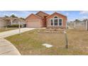 Well-maintained front yard with dry grass and landscaping that enhances the curb appeal of the property at 4617 Horseshoe Pick Ln, Valrico, FL 33594