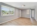Bright living room with sleek flooring, fresh paint, and ample natural light from a large window at 4940 Rosedale Ln, Holiday, FL 34690