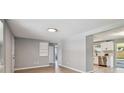 Bright living room with sleek flooring, fresh paint, and ample natural light at 4940 Rosedale Ln, Holiday, FL 34690