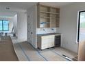 Bright bar area with custom built-in shelving, modern wine fridge and marble backsplash at 501 W Ross Ave # 2, Tampa, FL 33602