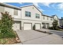 A townhouse complex featuring a garage and a quaint walkway to the front door at 6306 Tillandsia Pl, Tampa, FL 33610
