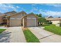 Well-maintained townhome with attached garages and well-kept lawns at 6514 Thicket Trl, New Port Richey, FL 34653