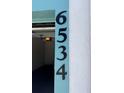 A close-up of address numbers 6534 mounted to the exterior of the home at 6534 Fairway Gardens Dr # 17-201, Bradenton, FL 34203