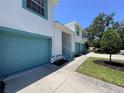Bright exterior elevation of townhome with turquoise garage door and trim detail at 6534 Fairway Gardens Dr # 17-201, Bradenton, FL 34203