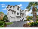 Stately three-story home with multi-car garage, elegant stair entrance and beautiful neutral color palette at 885 Seaview Cir # 20, Crystal Beach, FL 34681