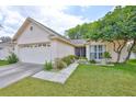 Lovely home featuring a well-manicured lawn, mature landscaping, and a welcoming entrance at 1005 Hardwood Dr, Valrico, FL 33596