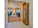 View of the living room and dining area featuring an antique clock and neutral color palette at 1005 Hardwood Dr, Valrico, FL 33596