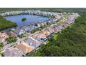 Overhead view of homes along a lake highlighting serene waterfront living with community docks and manicured lawns at 1015 Seagrape Dr, Ruskin, FL 33570