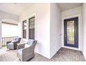 Inviting front porch features comfortable seating with stylish chairs and a view of the home's entry at 1015 Seagrape Dr, Ruskin, FL 33570