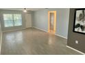 Spacious living room with wood-look flooring, lots of space, and neutral-toned walls at 1020 85Th N Ave # 222, St Petersburg, FL 33702