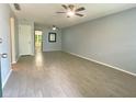 Bright living room featuring wood-look tile flooring, ceiling fans, and neutral paint at 1020 85Th N Ave # 222, St Petersburg, FL 33702
