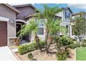 Inviting home exterior showcasing stone accents and a lushly landscaped yard with various plants and stone ground cover at 11688 Brighton Knoll Loop, Riverview, FL 33579