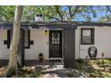 Front door with a decorative wreath and a welcoming light fixture and gray trim at 1247 21St St, Sarasota, FL 34234