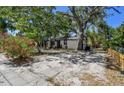 Cozy single-story home with lush, mature trees and a spacious, sandy front yard at 1247 21St St, Sarasota, FL 34234