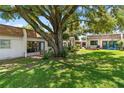 Relaxing backyard featuring a cozy patio, a spacious yard, and mature trees at 1278 Mission Cir # 45B, Clearwater, FL 33759