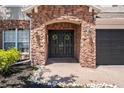 Elegant double front doors are adorned with decorative wreaths and encased in beautiful stonework, giving a warm welcome at 12935 Solola Way, Trinity, FL 34655