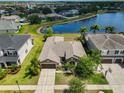 Aerial view of the single-story home, showcasing the community, and backyard pond at 13742 Artesa Bell Dr, Riverview, FL 33579