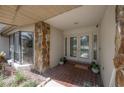 Inviting front porch features double doors, stone accents, and tiled flooring, creating a welcoming entrance at 13906 Captains Reef Ct, Tampa, FL 33624