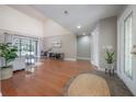 Open-concept living room boasts wood floors, vaulted ceilings, and abundant natural light from sliding glass doors at 13906 Captains Reef Ct, Tampa, FL 33624