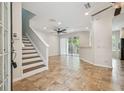 Bright living room featuring tile floors, recessed lighting, and a staircase to the second level at 14537 Mirabelle Vista Cir, Tampa, FL 33626