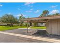Exterior view of a carport showing structure and yard at 15 Tads Trl, Oldsmar, FL 34677
