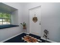 Inviting foyer with welcome mat and charming decor at 1715 Belleair Forest Dr # C, Belleair, FL 33756