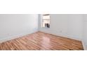 Bright bedroom featuring sleek hardwood floors and crisp white walls at 18106 Lembrecht Way, Tampa, FL 33647