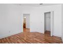 Bedroom offers hardwood floors, white walls, and access to closet and adjacent bath at 18106 Lembrecht Way, Tampa, FL 33647