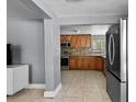 A well-equipped kitchen with stainless steel appliances and tiled flooring at 2026 Cocoanut Ave, Sarasota, FL 34234
