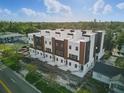 New construction townhomes featuring a modern design with a combination of white, black, and wood-look accents at 2104 4Th S St, St Petersburg, FL 33705