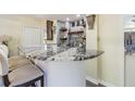 A luxurious bar with a swirling marble countertop and comfortable seating set to entertain Gathering and friends at 2114 S Venus St, Tampa, FL 33629