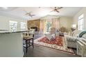 Open concept living space with seating area and a stone fireplace as focal point at 2114 S Venus St, Tampa, FL 33629