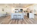 Bright kitchen with white cabinets, stainless steel appliances, a center island, and modern pendant lighting at 2161 Aqui Esta Dr, Punta Gorda, FL 33950