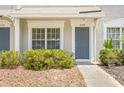 Charming townhouse featuring a blue door and desert landscaping at 2306 Lake Woodberry Cir, Brandon, FL 33511