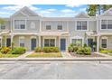 Charming townhouse featuring landscaped yards and grey exterior paint at 2306 Lake Woodberry Cir, Brandon, FL 33511