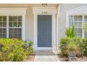 Inviting front entry of townhome featuring a blue door and desert landscaping at 2306 Lake Woodberry Cir, Brandon, FL 33511