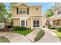 Inviting front exterior of townhome with well-maintained landscaping and a sidewalk at 2373 Hounds Trl, Palm Harbor, FL 34683