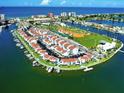 Stunning aerial view of waterfront condos, a marina, and recreational amenities at 250 Medallion Blvd # H, Madeira Beach, FL 33708