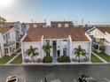 An attractive exterior shot of a two-story townhome with well-maintained landscaping and easy access to parking at 250 Medallion Blvd # H, Madeira Beach, FL 33708