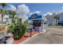 View of guard house at complex entrance with landscaped plants around it at 250 Medallion Blvd # H, Madeira Beach, FL 33708