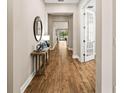 Inviting foyer featuring wood floors and an elegant entry to the home at 2644 Leafwing Ct, Palm Harbor, FL 34683
