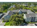 An aerial view captures the building's layout, complemented by trees and the surrounding neighborhood at 330 Promenade Dr # 206, Dunedin, FL 34698