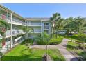 This inviting condo building offers multiple balconies and well-maintained landscaping, creating a welcoming ambiance at 330 Promenade Dr # 206, Dunedin, FL 34698