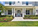 Welcoming front entrance featuring a decorative wreath, symmetrical planters, and manicured landscaping at 3905 W San Obispo St, Tampa, FL 33629