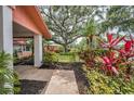 Landscaped front yard featuring vibrant plants leading up to the charming entrance at 40 Pine Lake Dr, Oldsmar, FL 34677