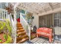 Welcoming entryway with a decorative bench and stairs, leading to a charming beach house at 412 80Th St, Holmes Beach, FL 34217