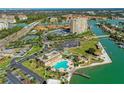 An aerial view of a beautiful waterfront community featuring lush landscaping, pool, tennis courts, and marina at 4900 Brittany S Dr # 811, St Petersburg, FL 33715
