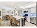 Modern kitchen features stainless steel appliances, a center island with seating, and an adjacent dining area at 4900 Brittany S Dr # 811, St Petersburg, FL 33715